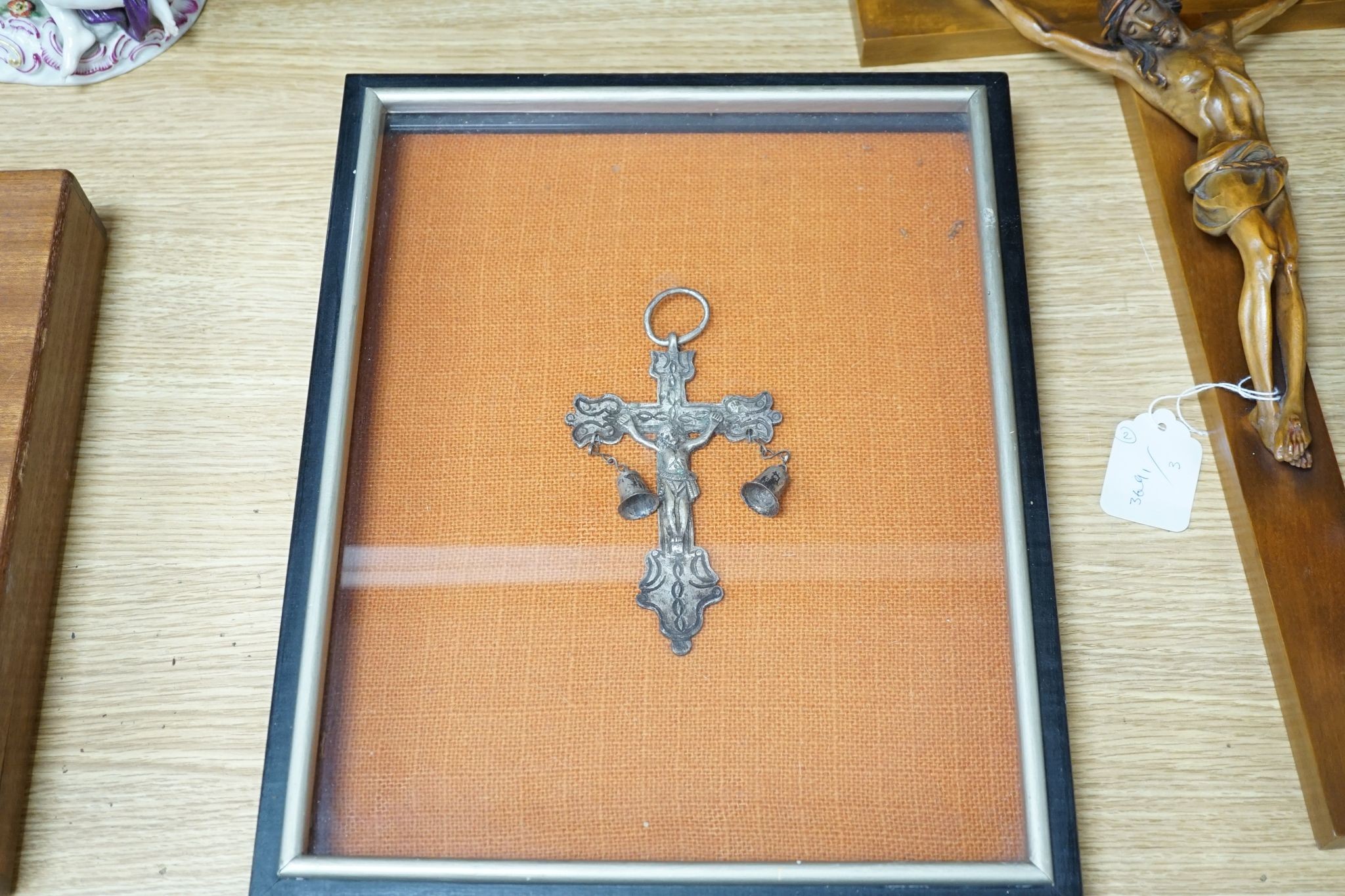 A carved crucifix and a framed metal Peruvian colonial crucifix, 50cm